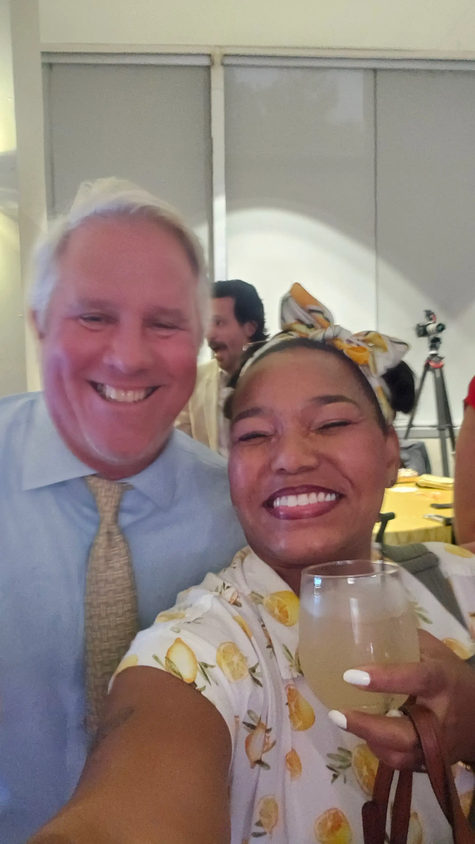 A man and woman pose for a picture at a high end event, enjoying a glass of Touch O Magic Lemonade.